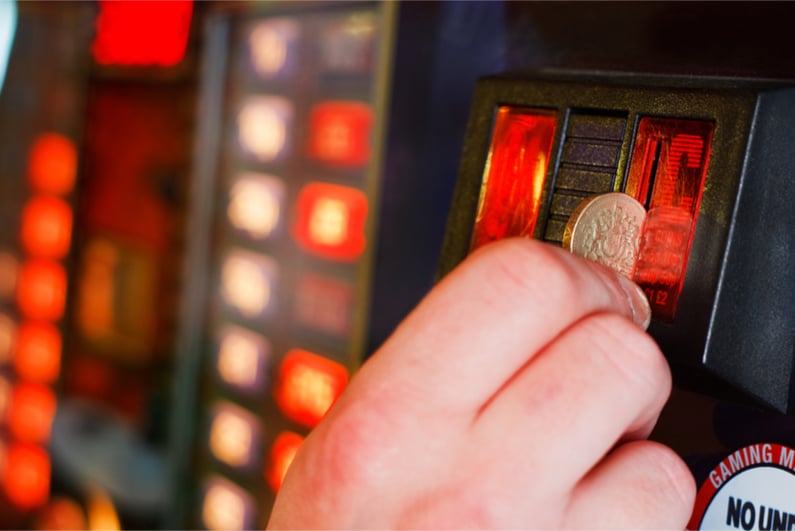 A coin being put into a gambling machine