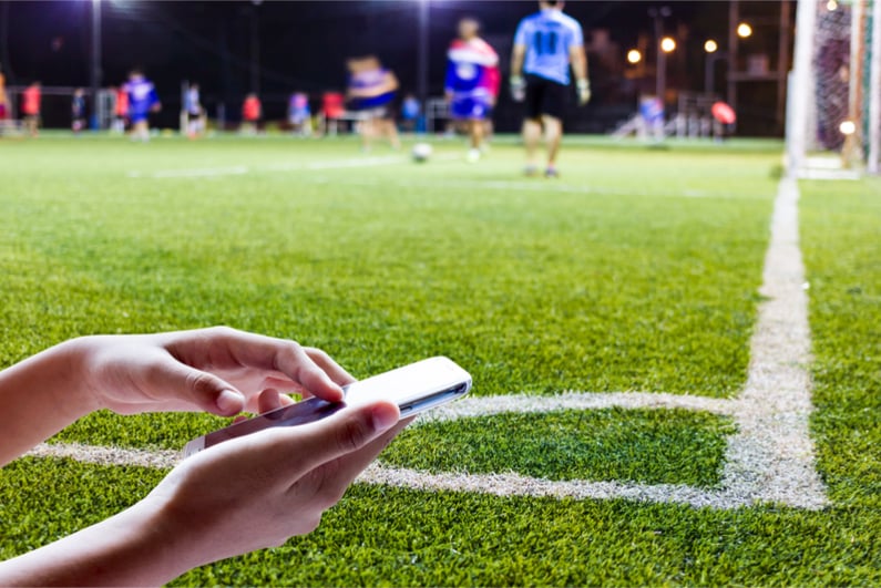 A football pitch and a mobile phone