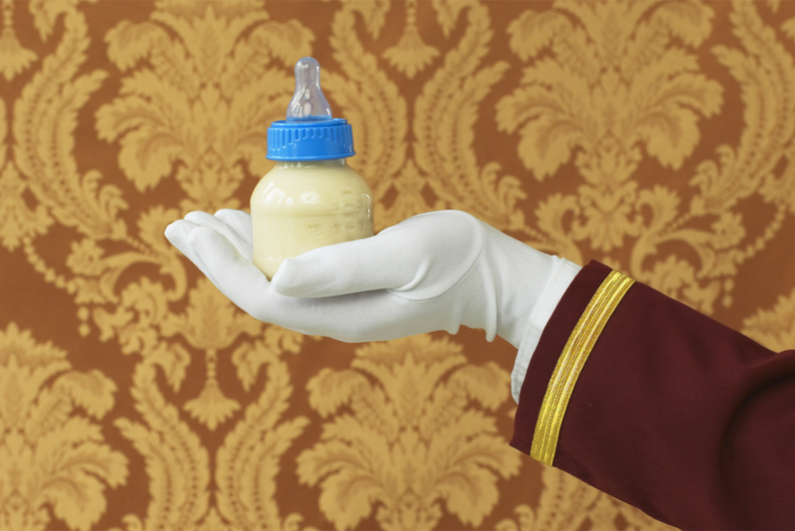Butler's hand holding a baby's bottle