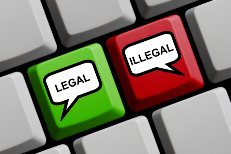 omputer Keyboard with speech bubble symbols on red and green key showing Legal or Illegal