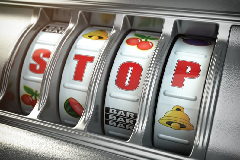 Stop gambling addiction concept. Slot machine with text STOP