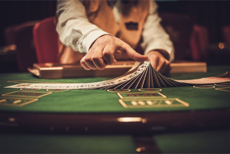 photo ID: 605080553 Croupier behind gambling table in a casino.