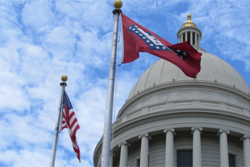 Arkansas State Capitol building cupola (dome) with US flag and Arkansas state flag
