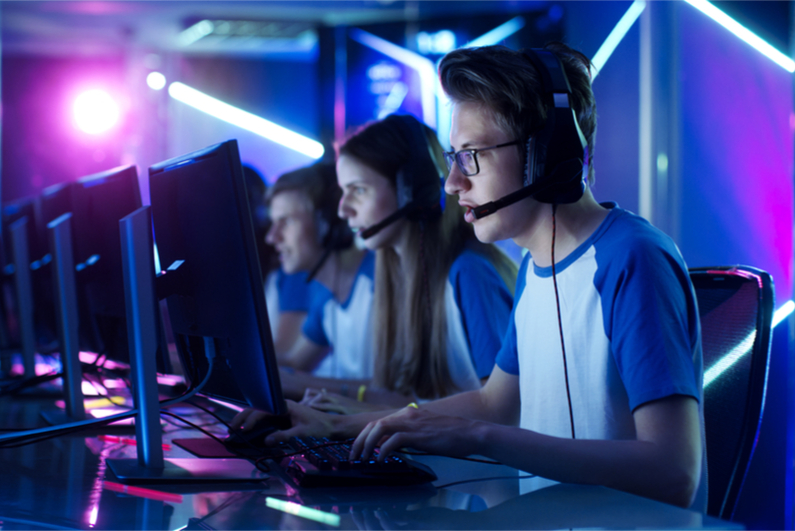 Team of Teenage Gamers Play in Multiplayer PC Video Game on a esport Tournament