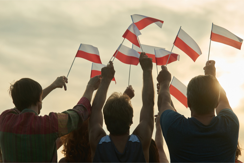 Family waving Polish flags