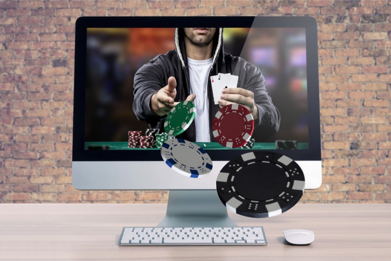 Online poker game, with the poker player coming out of the computer screen.