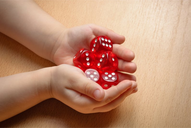 Child's hands holding dice