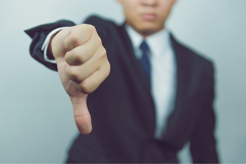 Businessman showing thumbs down