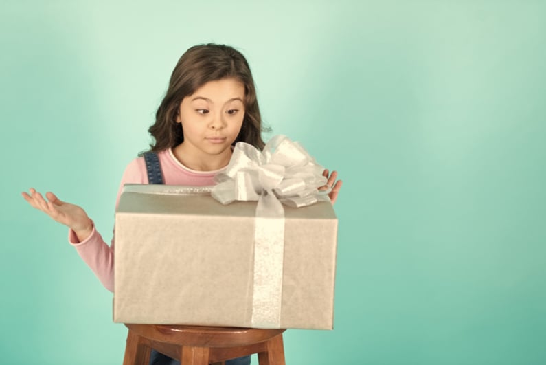 Smiling little girl with gift box