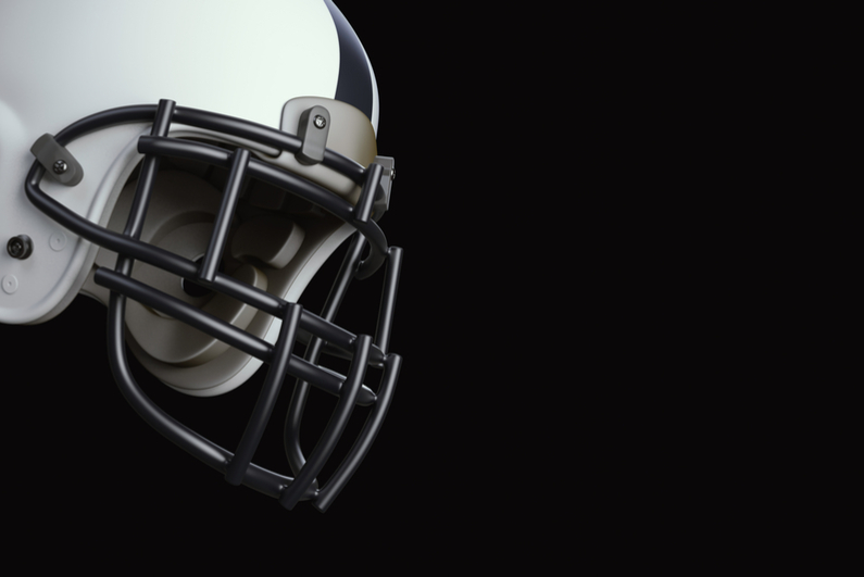 American football helmet against dark background