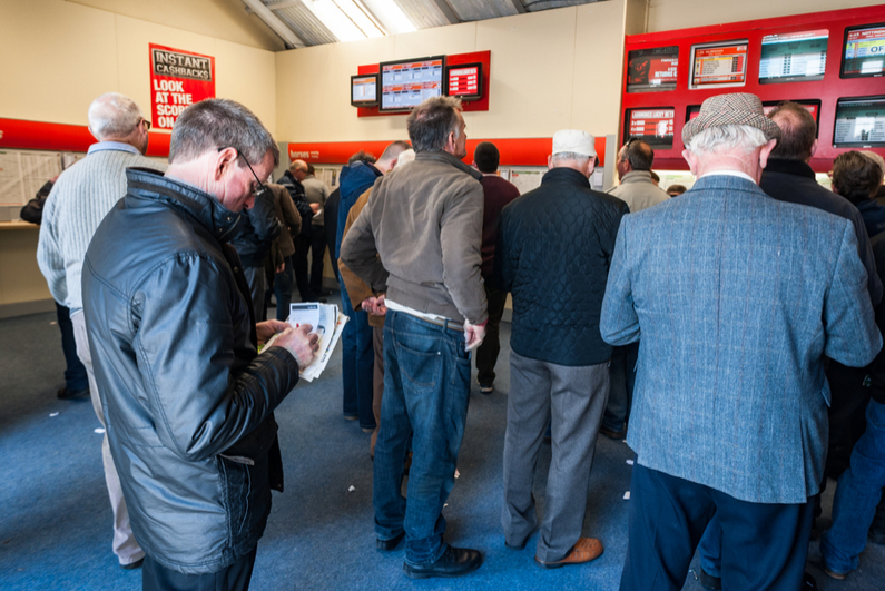 Men watching horses race