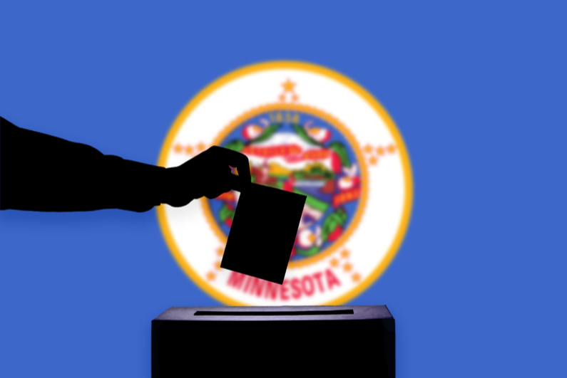 Ballot box in front of Minnesota flag