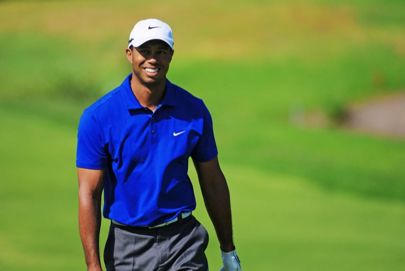 Tiger Woods striding down a fairway