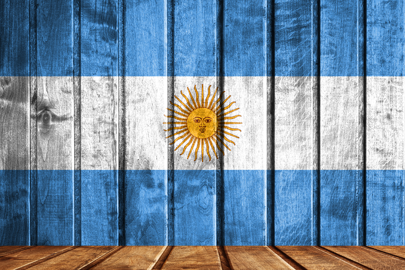 Wooden background with a flag of Argentina.