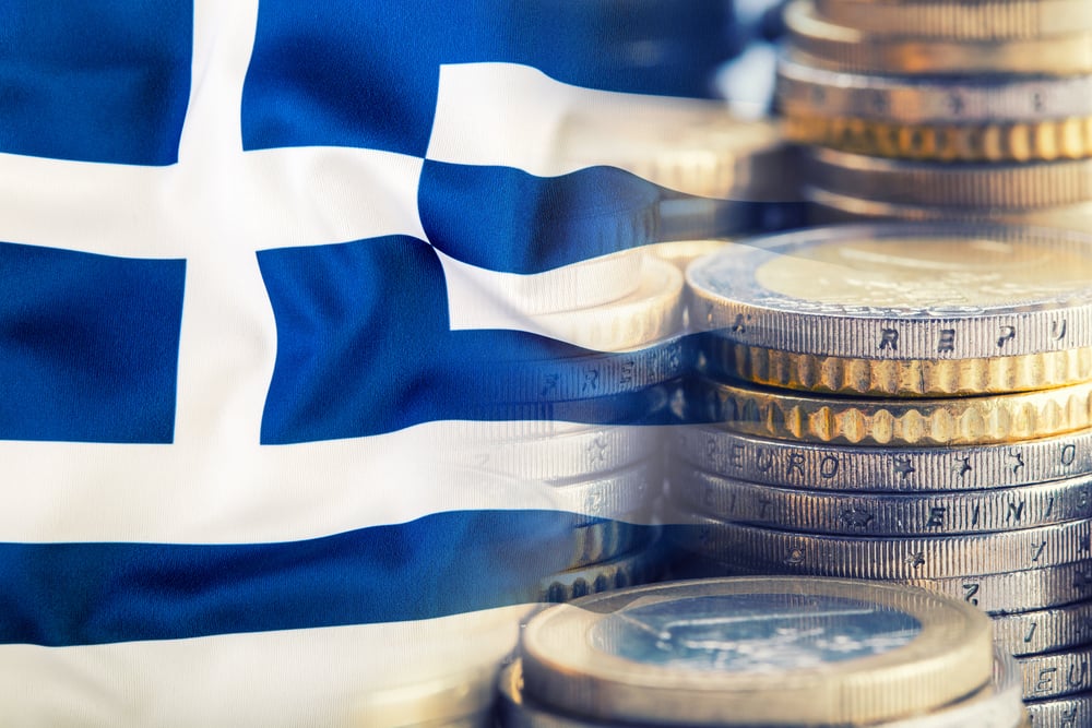 greek flag and euro coins