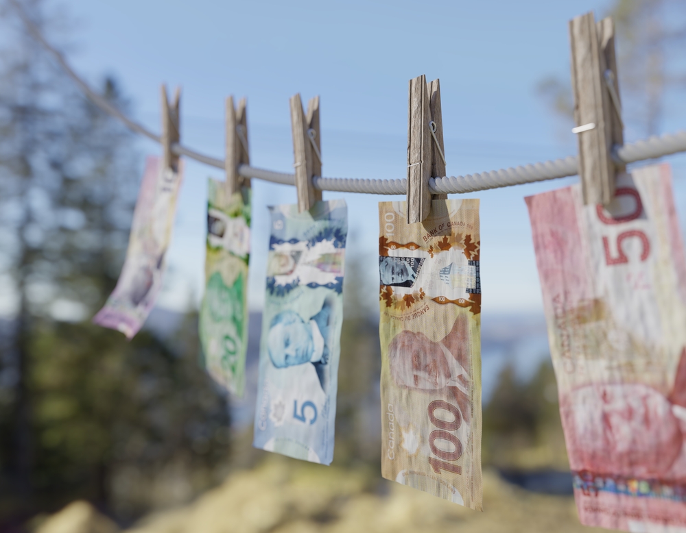 Canadian money hung out on clothes line