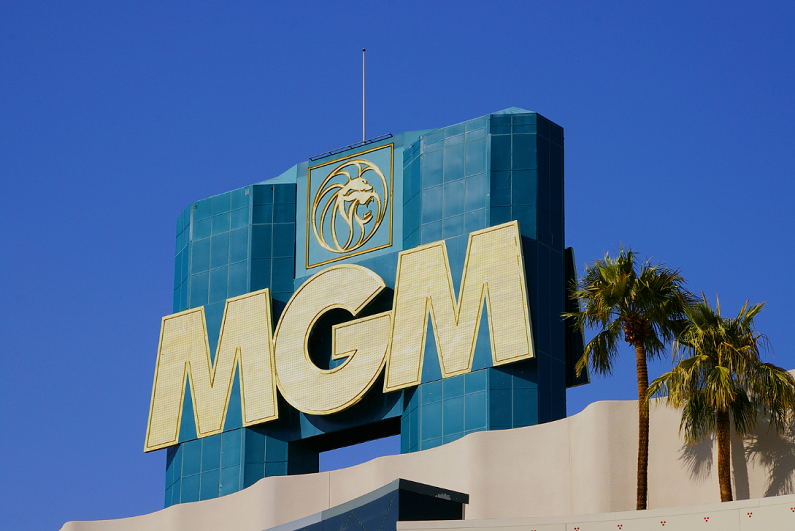 Close-up view of the MGM Casino and Hotel sign set against a deep blue summer sky.