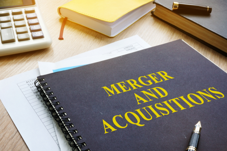 Merger and Acquisition book on a desk.