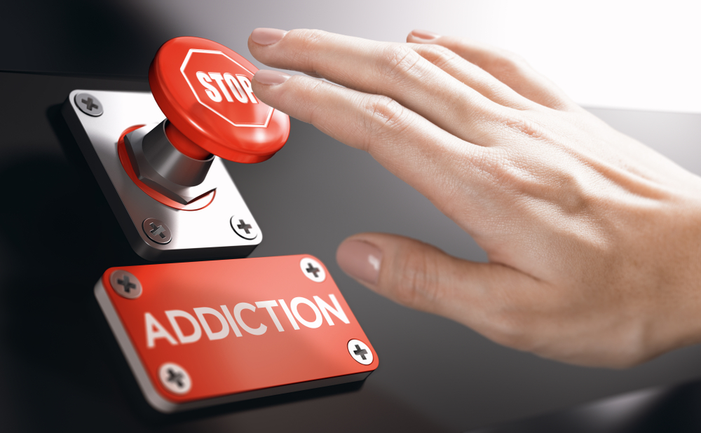 hand pushing stop addiction button