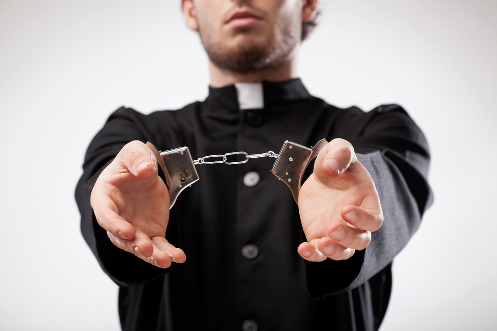 priest in handcuffs