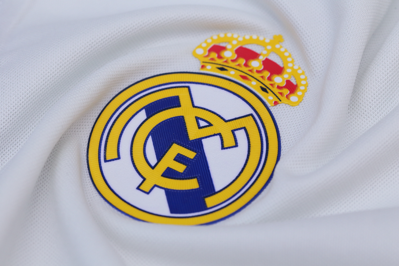 Real Madrid badge on white jersey