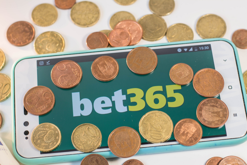 bet365 smartphone app with coins scattered about
