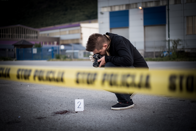 photographer taking picture at a crime scene