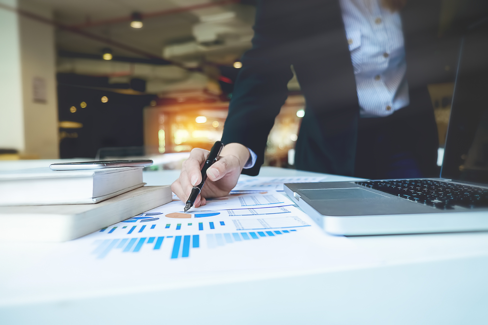 businessperson pointing at charts