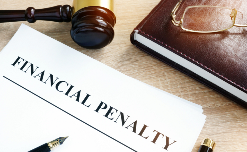 document with title "financial penalty" on a desk
