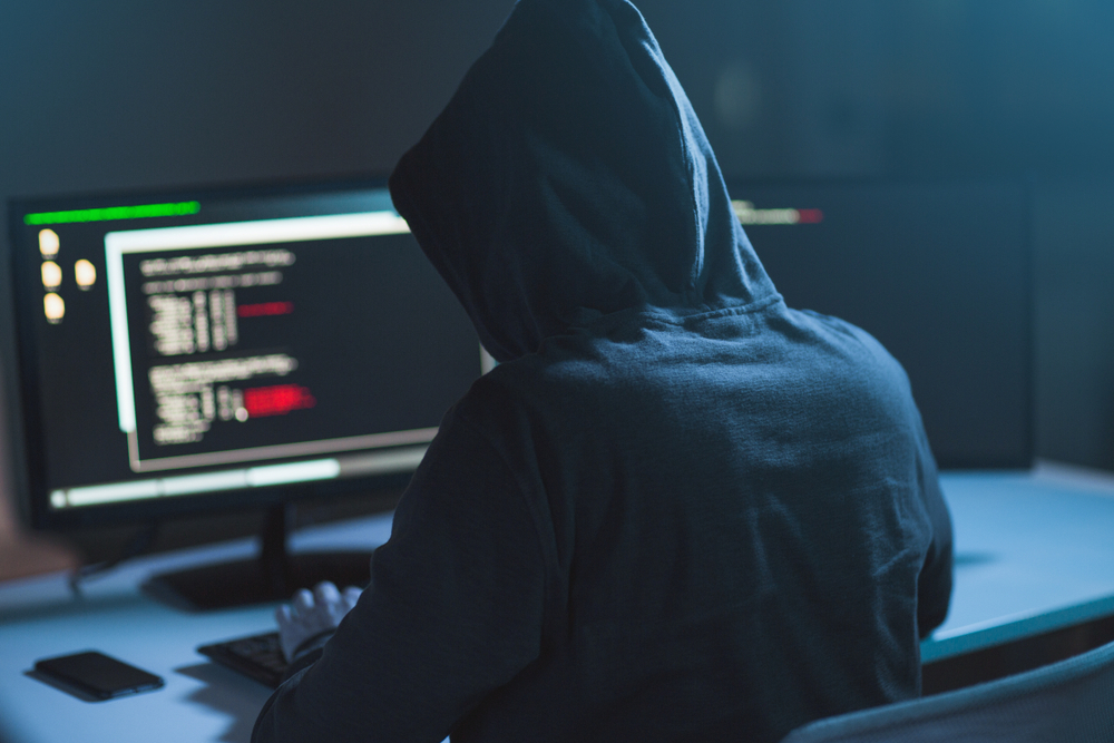 hacker at computer carrying out a cyberattack