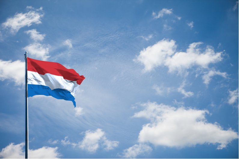 Netherlands flag against blue sky