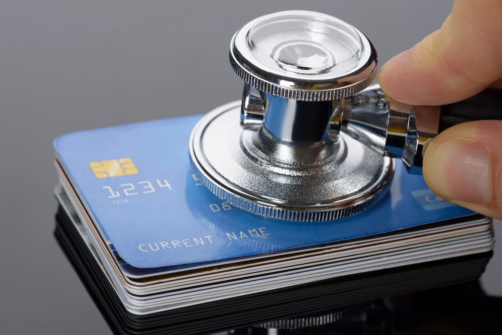 stethoscope placed against stack of credit cards