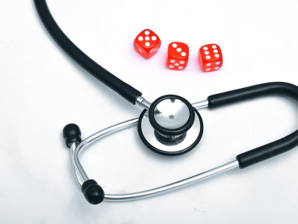 stethoscope and three red dice