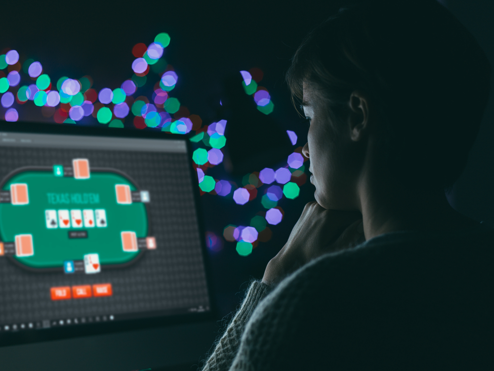 woman playing online poker on desktop