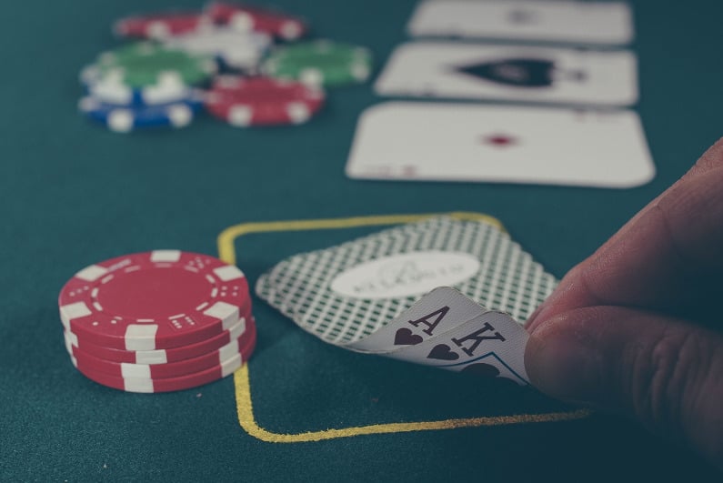 Poker player peeking at A-K during live game