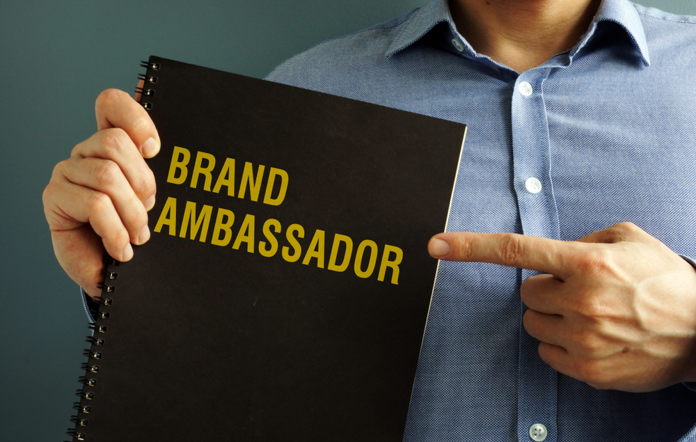 man pointing at brand ambassador document