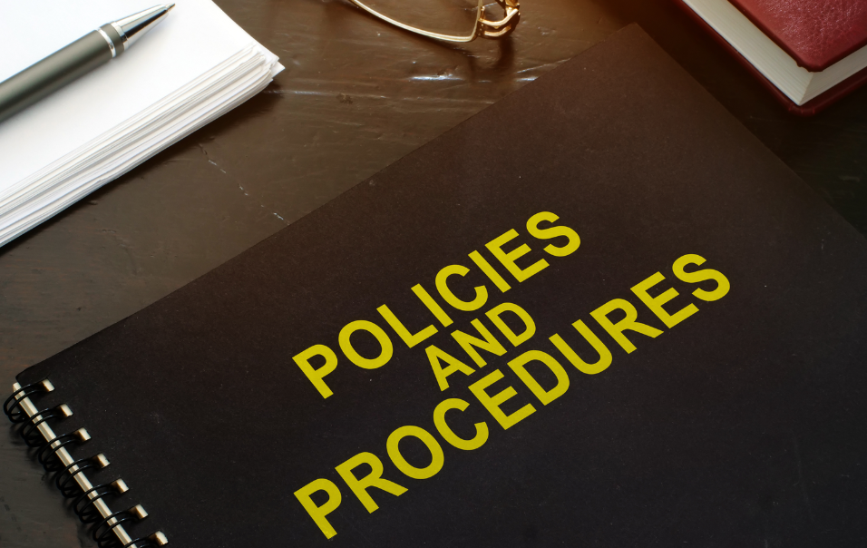 policies and procedures company documents on a desk