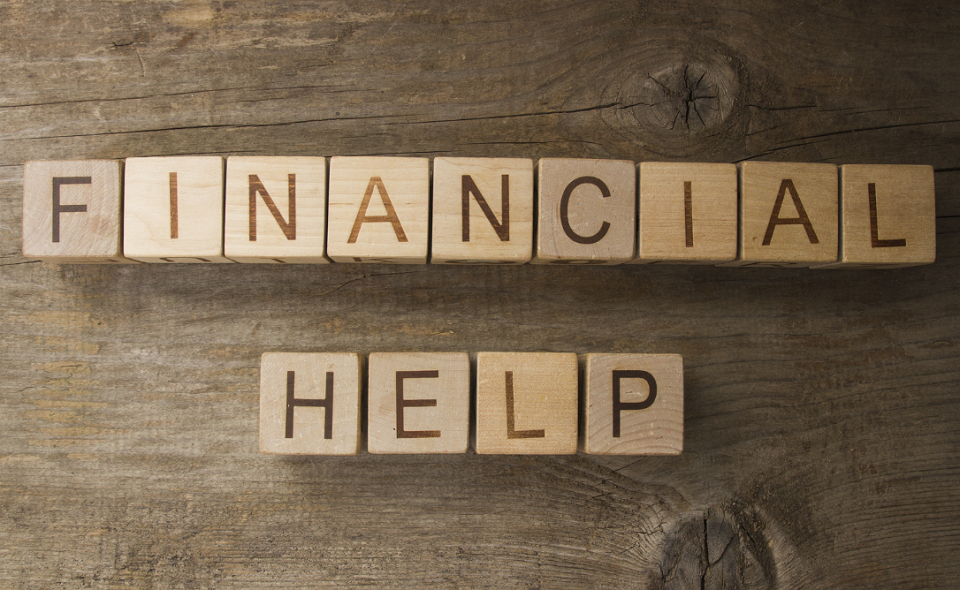 Financial help text on a wooden background