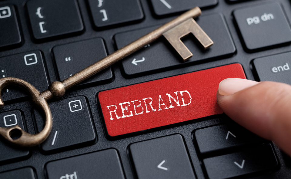 finger on keyboard with word "REBRAND"