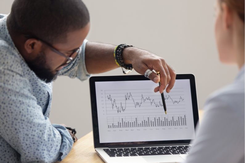 Man explaining line graph on laptop