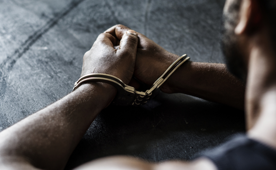 arrested man with handcuffs on wrists