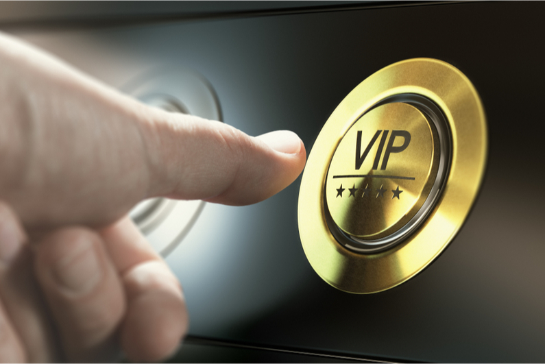 Person pressiing gold "VIP" button