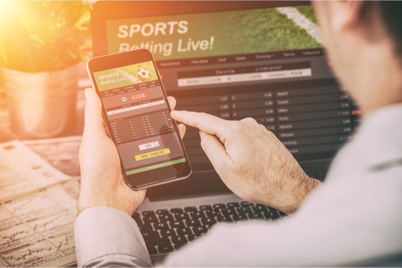 Businessman placing a bet on a smartphone