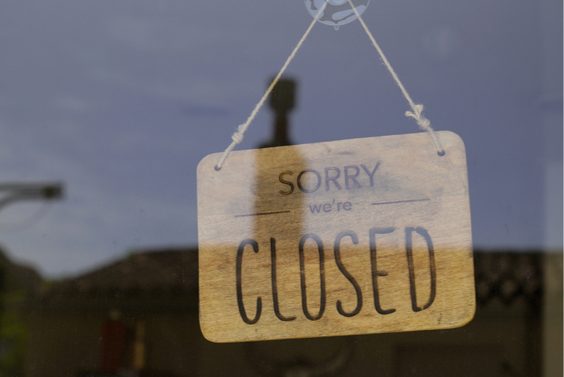 "Sorry, we're closed" sign in door