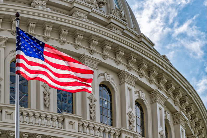 American flag flying in front of US Capitol Building