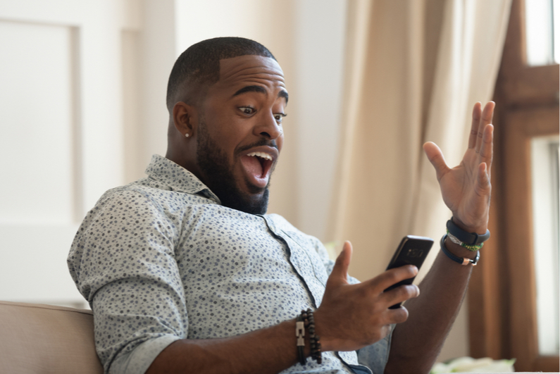 Man excited about something on his phone