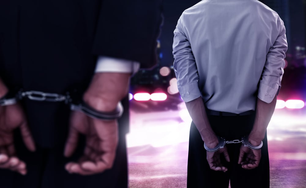 two men in handcuffs