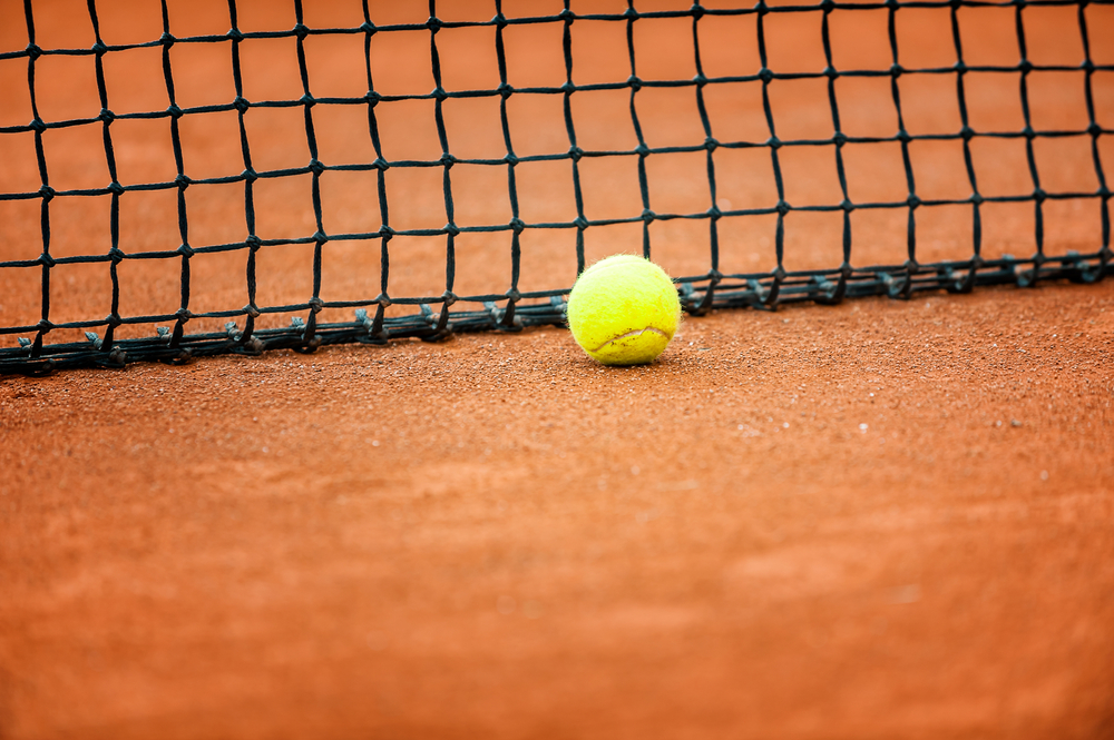 tennis ball near the net on a court