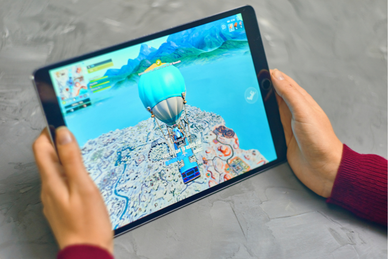 Woman playing Fortnite on an Apple iPad