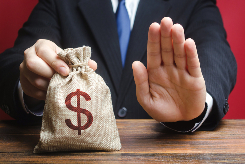 Businessman stopping viewer from taking a bag of money